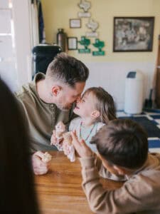 dad and daughter kissing noses at ice cream date