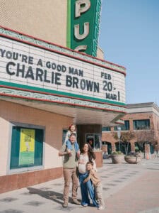 family outside old fashioned theatre downtown denton