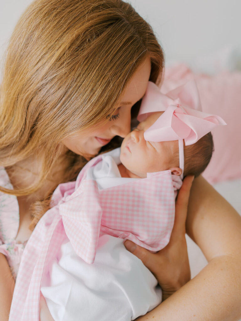 mom holding newborn baby in frisco, TX