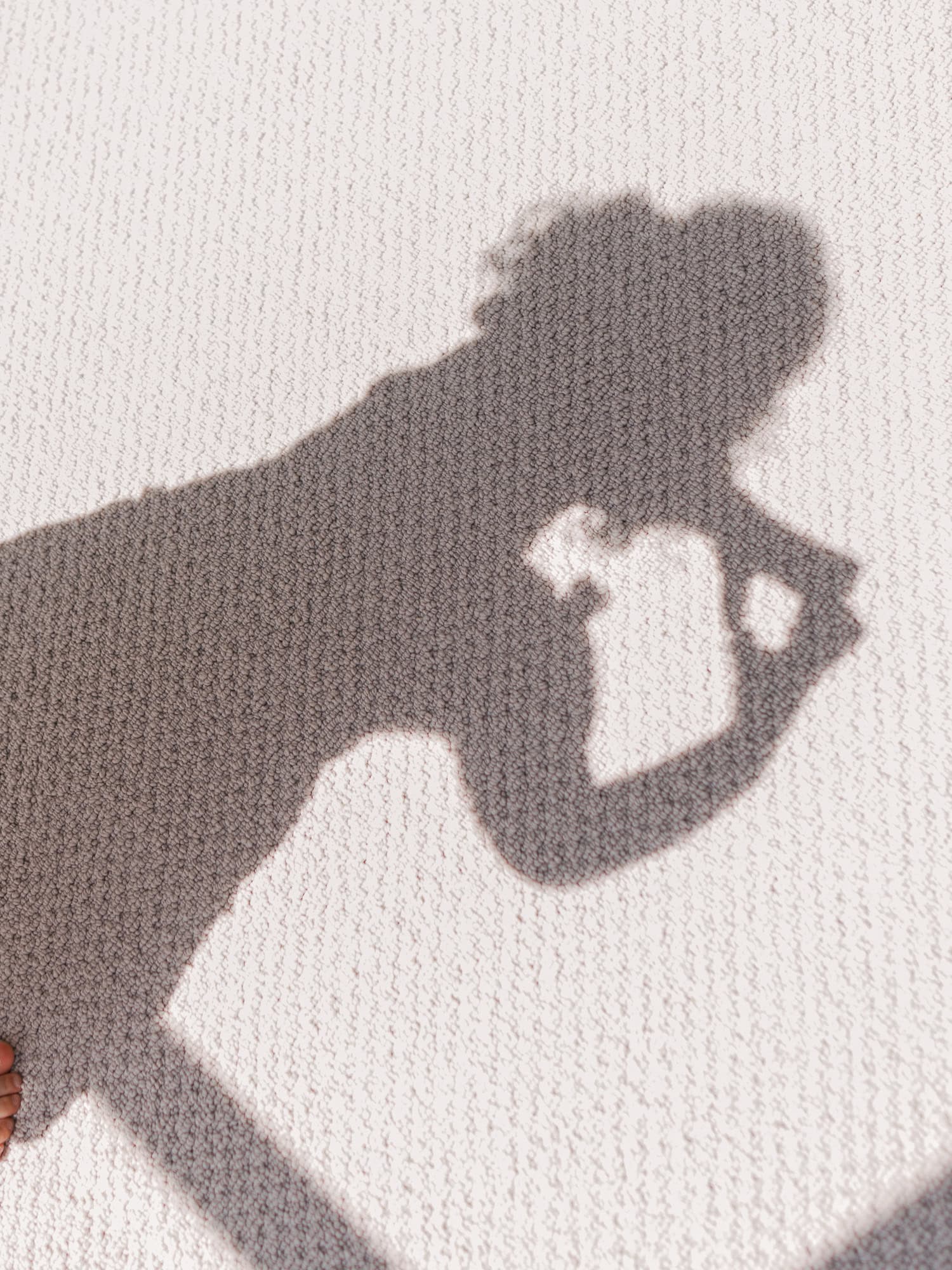 child seeing her shadow making a heart shape